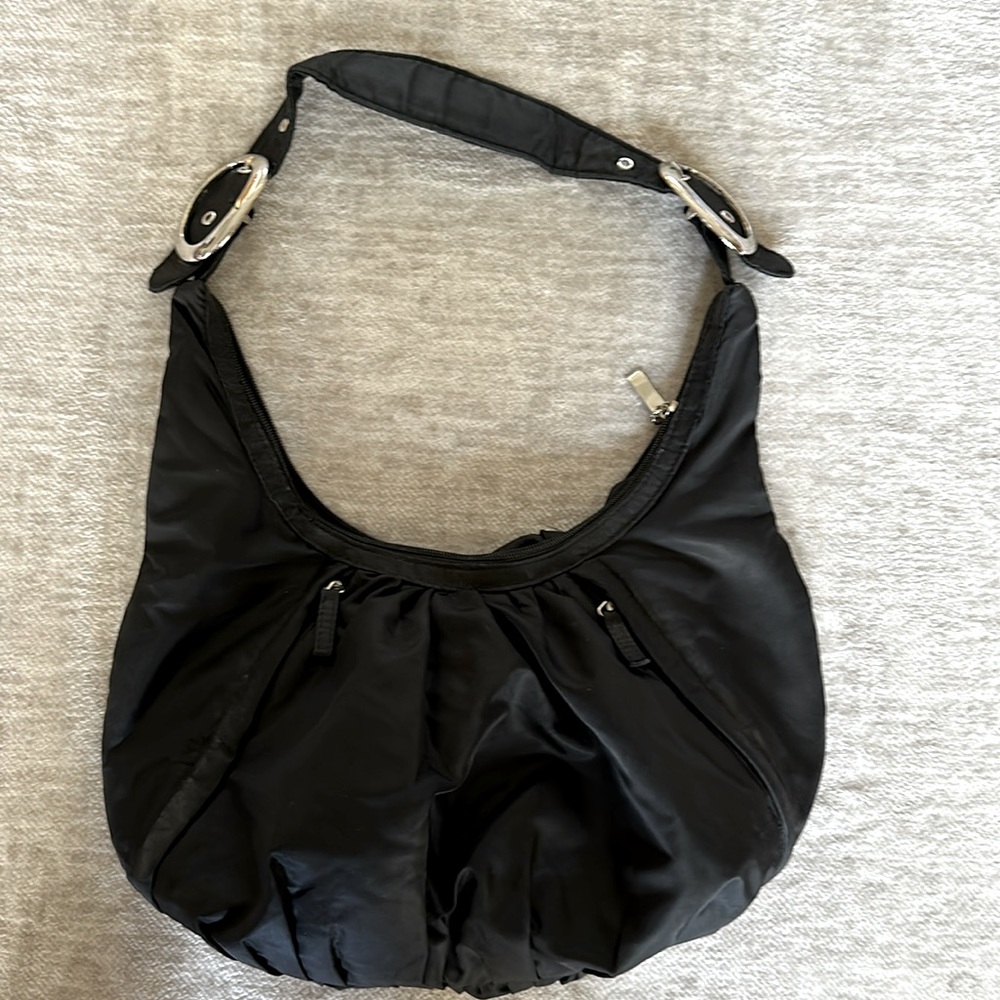 Avon black nylon boho type bag with cute buckle details on the straps.